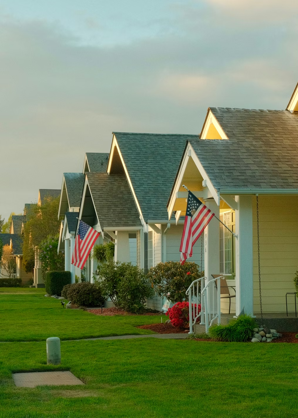 Row of suburban homes with American flags